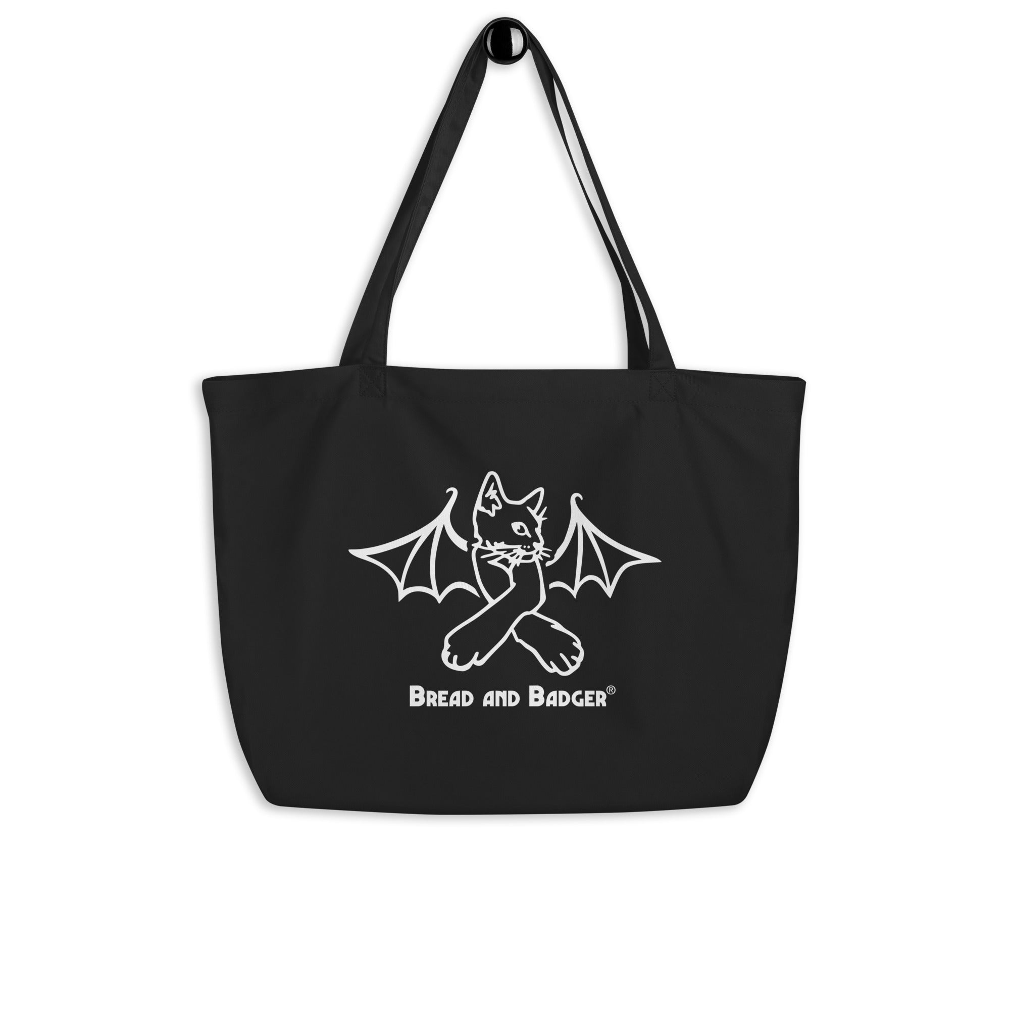 Black tote bag with a white cat bat design and 'Bread and Badger' text on a white background