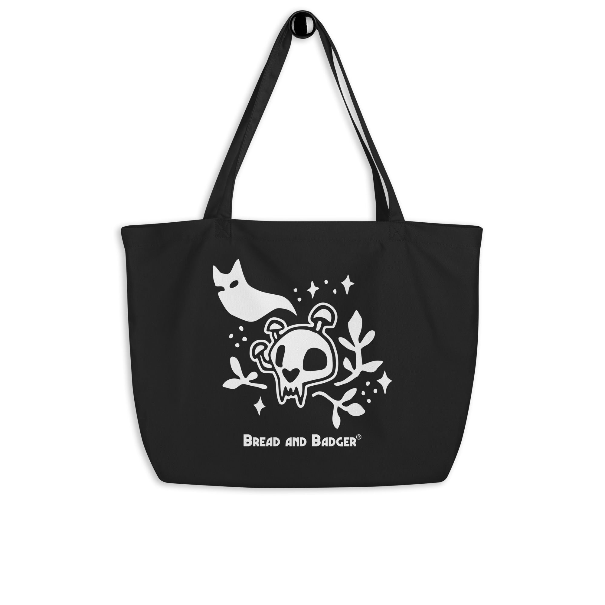 Black tote bag with white skull and cat ghost design and 'Bread and Badger' logo.