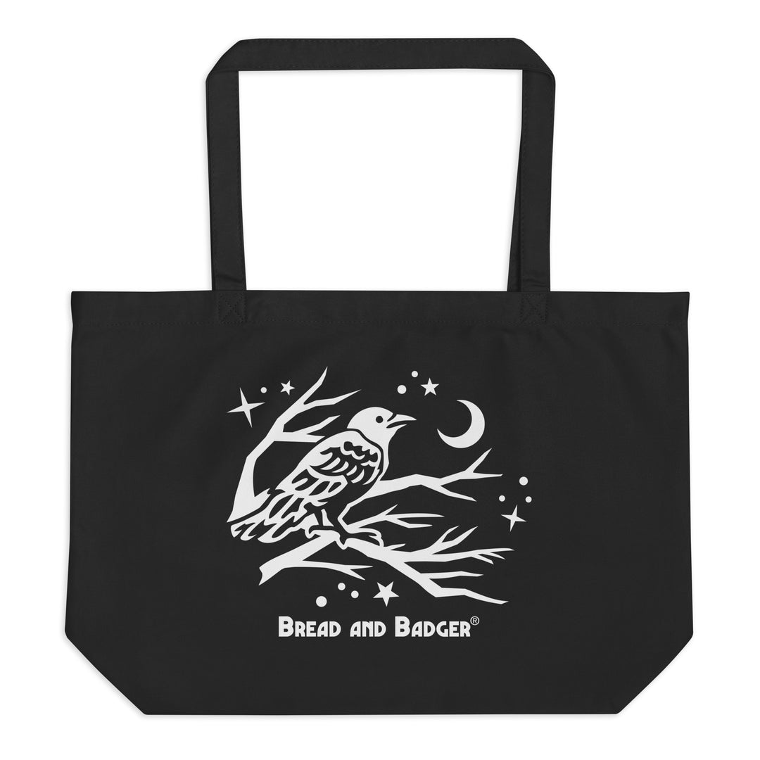Black tote bag with a white bird design and 'Bread and Badger' logo on a white background
