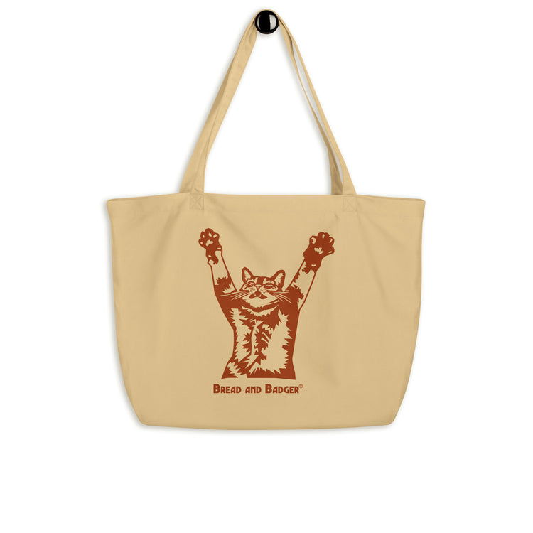 Beige tote bag with a brown graphic of a cat and text on a white background