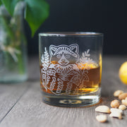 cocktail glass etched with a cute raccoon