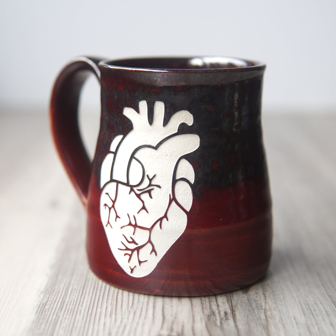 anatomical heart engraved on a red and silver mug