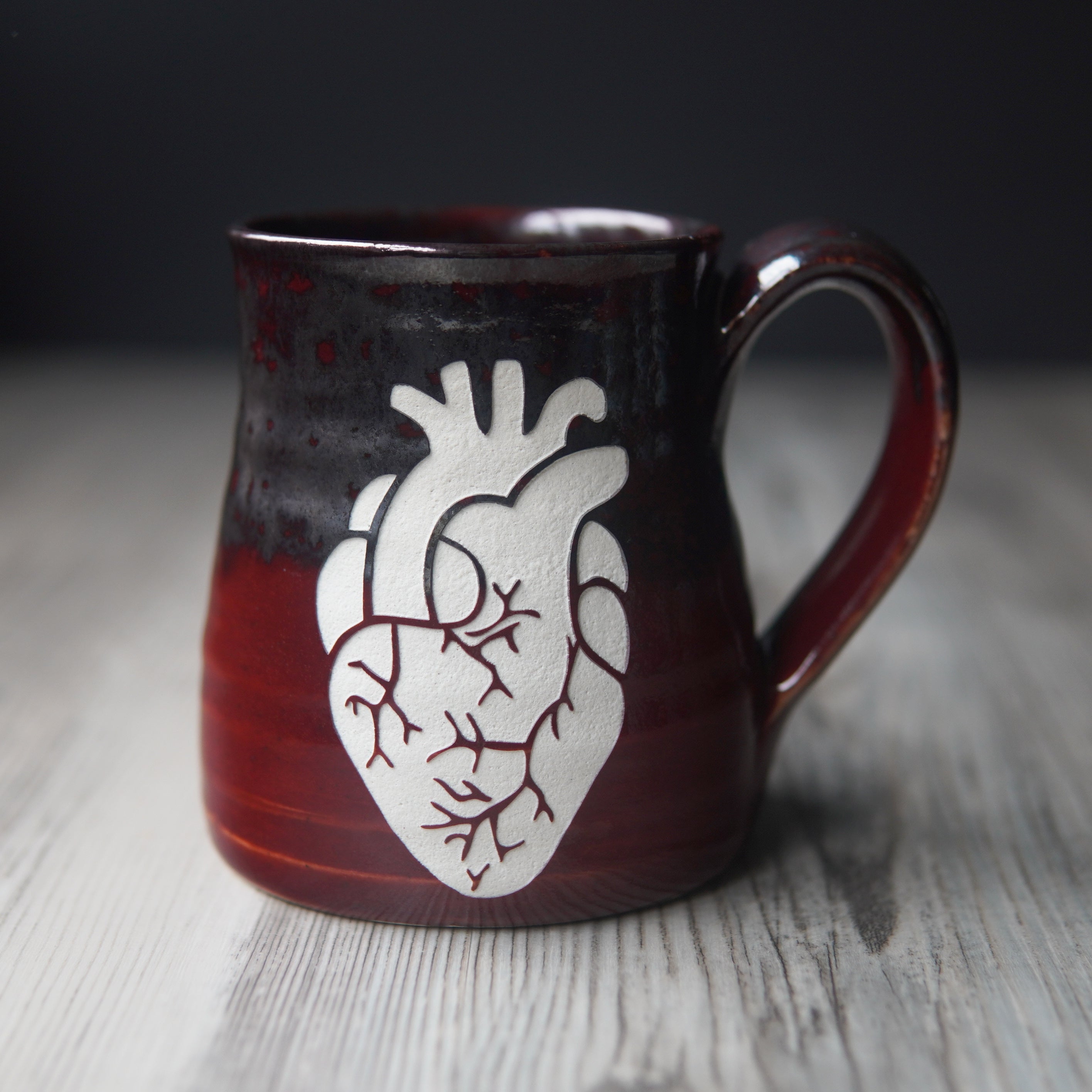 anatomical heart engraved on a red and silver mug