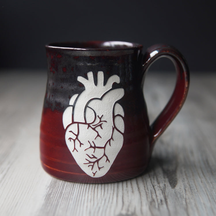 anatomical heart engraved on a red and silver mug