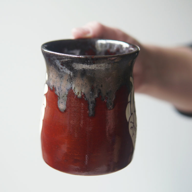 handmade pottery mug engraved with an anatomical heart, seen from the side