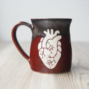 gray and red handmade mug engraved with an anatomical heart