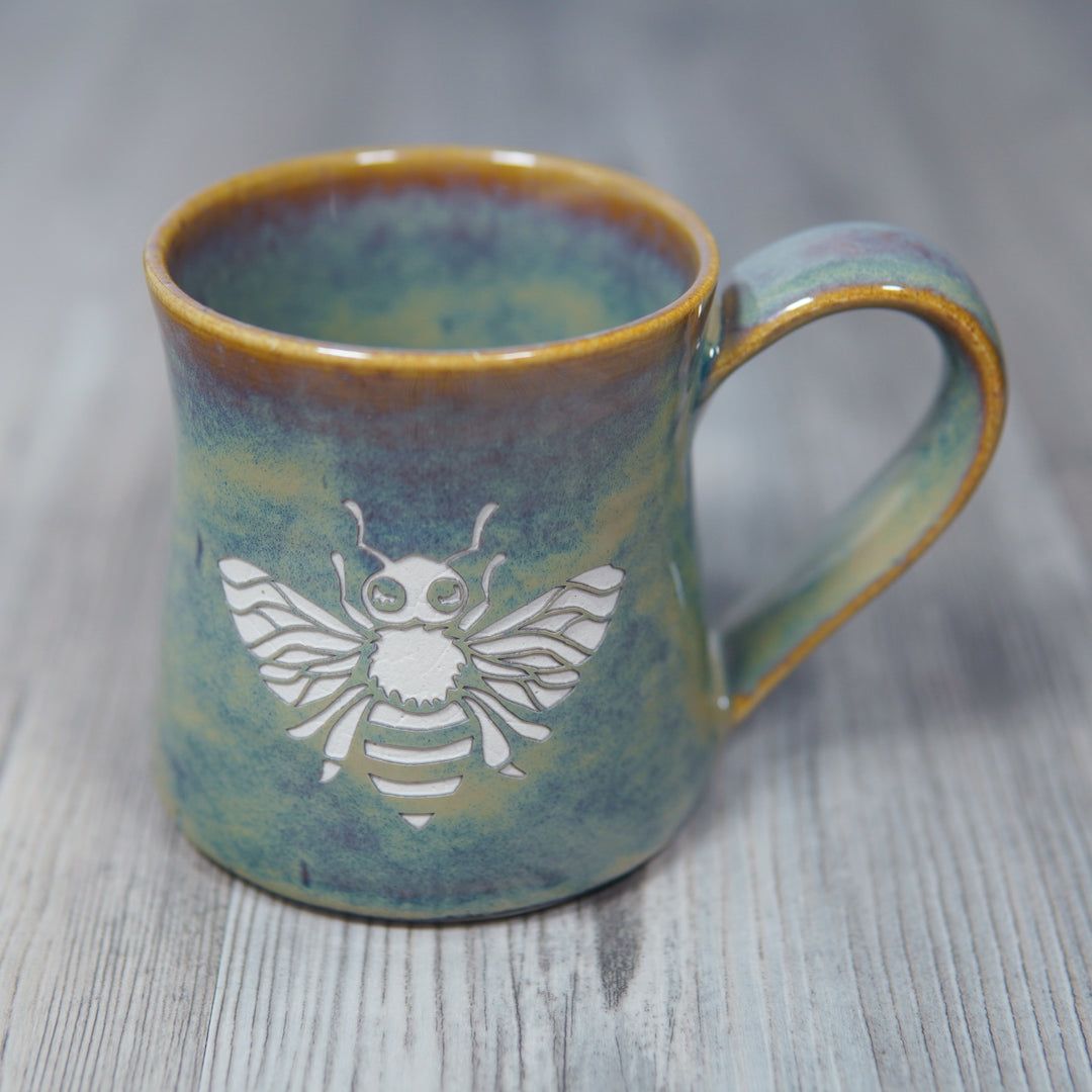 pottery mug engraved with a honey bee