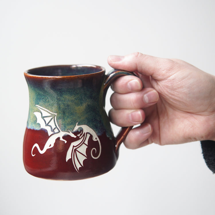 Dragon mug held by a hand