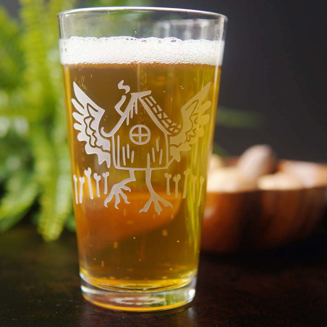 etched Baba Yaga pint glass, full of beer