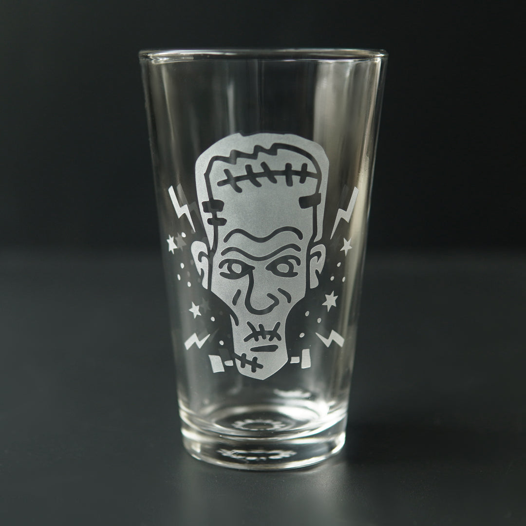 Etched pint glass with Frankenstein's monster's head, lightning bolts, and sparks