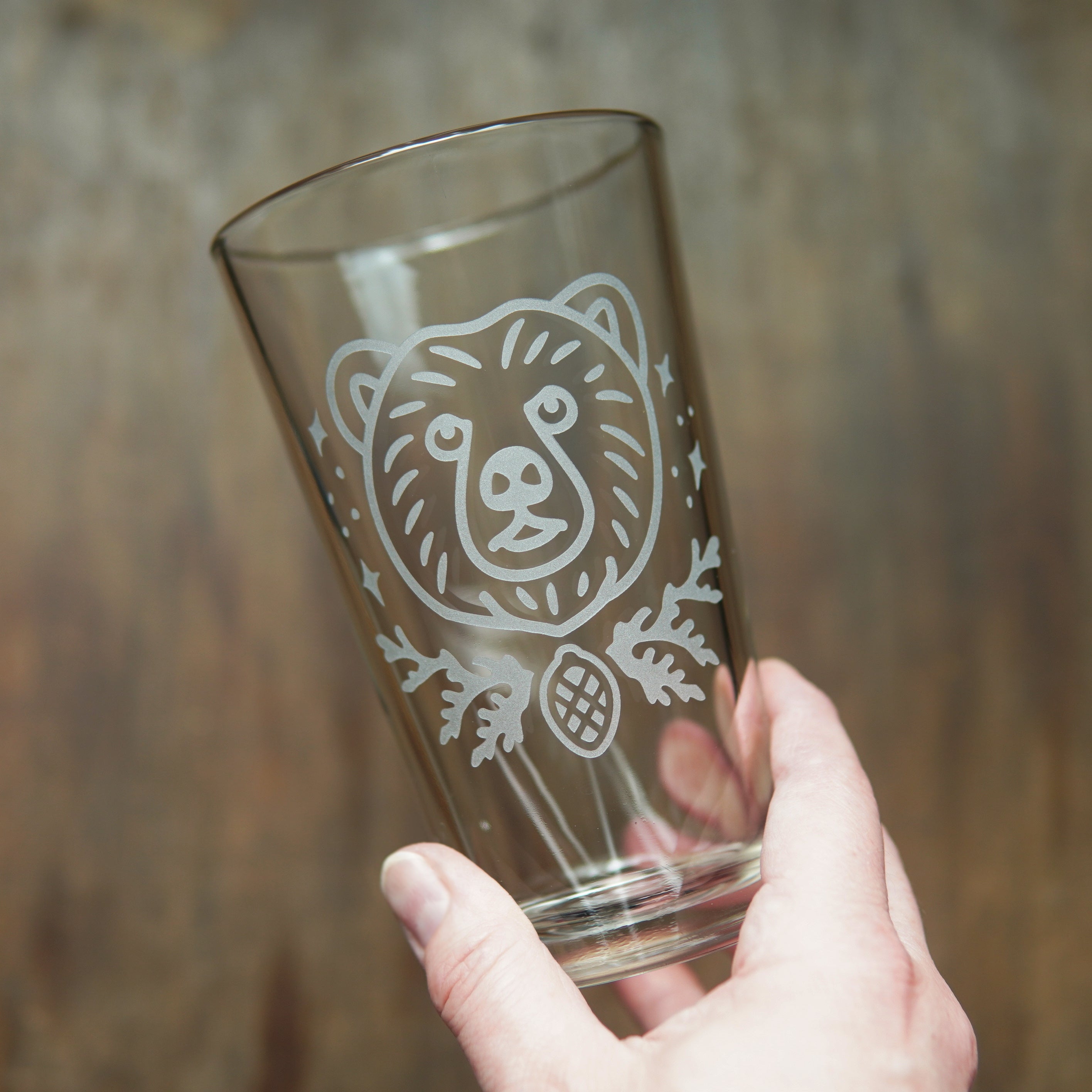 Bear pint glass held in a hand