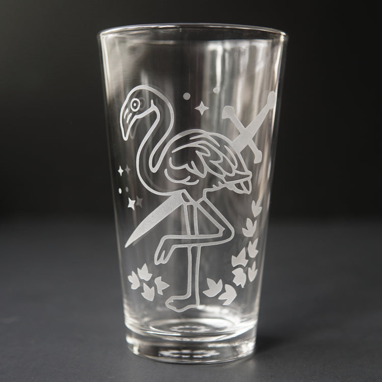 pint glass etched with a flamingo and sword