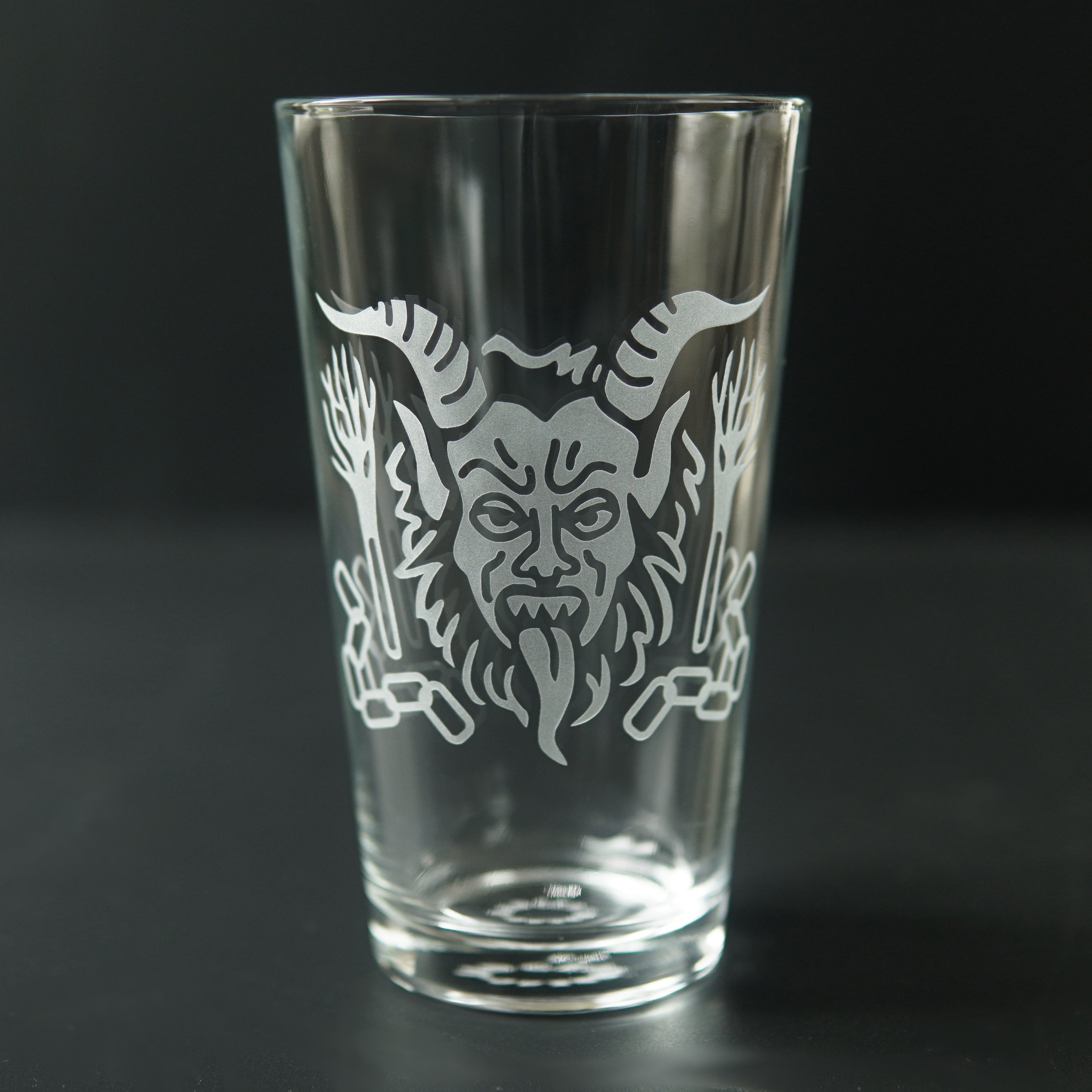 Pint glass engraved with Krampus' head