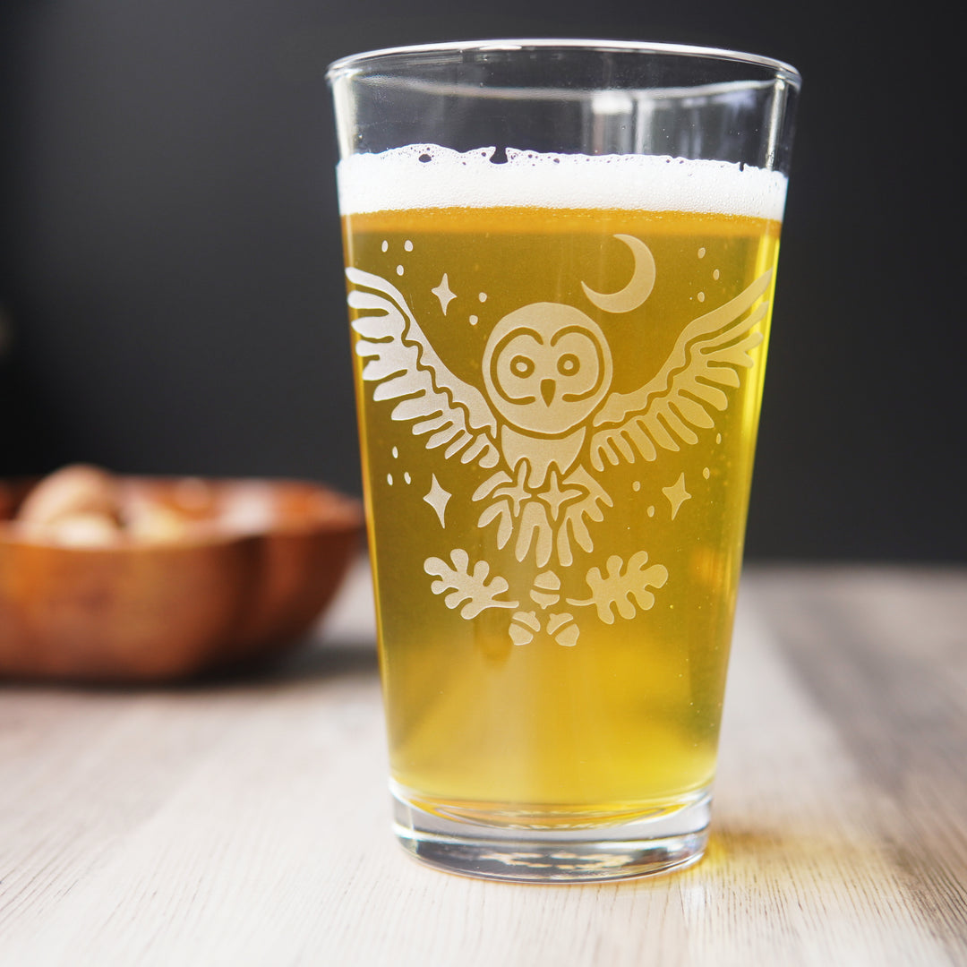 flying owl etched pint glass full or yellow beer