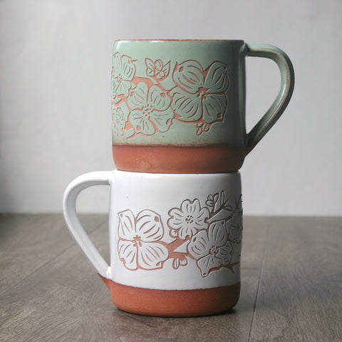 dogwood flower mugs in pistachio green and white over red clay
