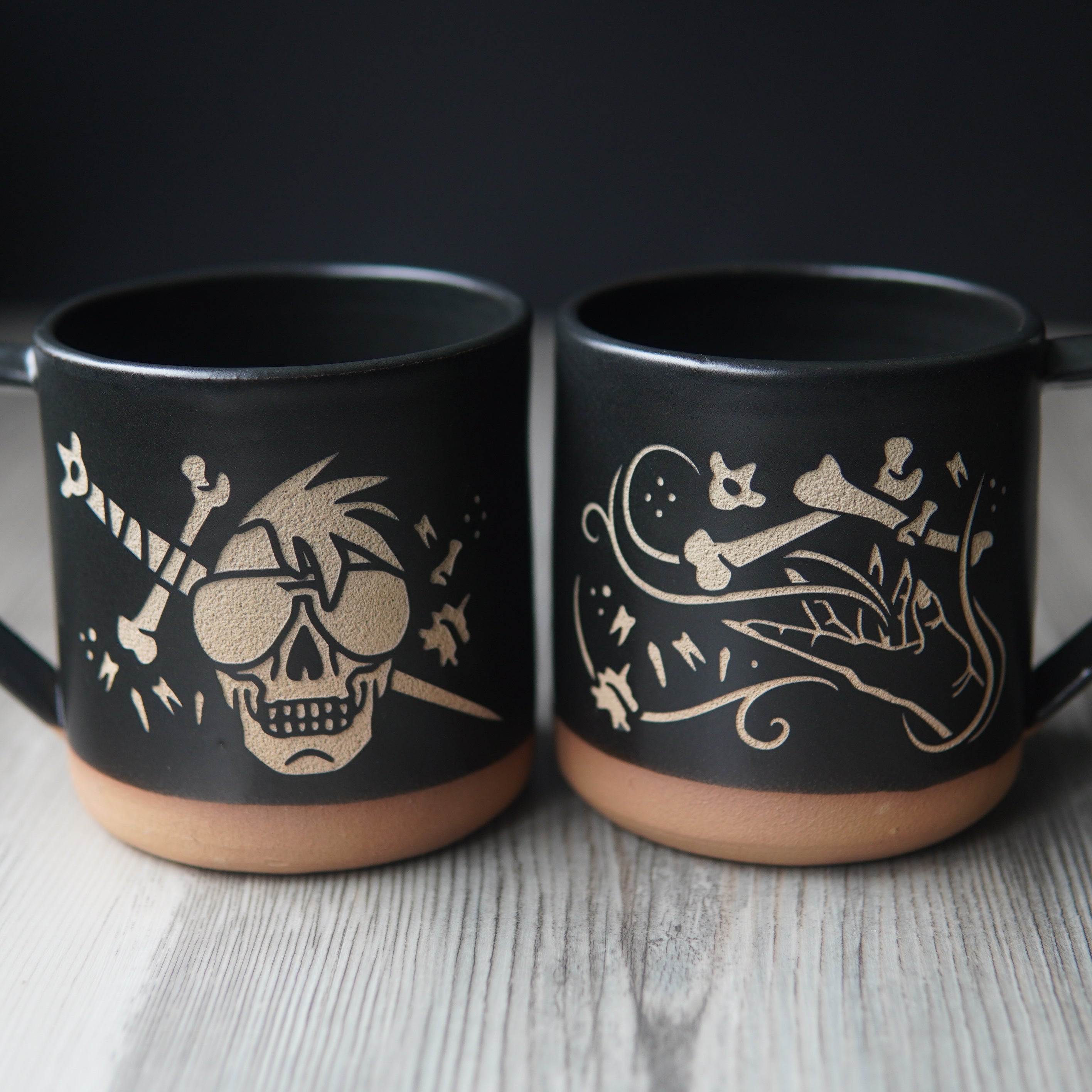 skull with bone sword mug next to hand summoning bones mug
