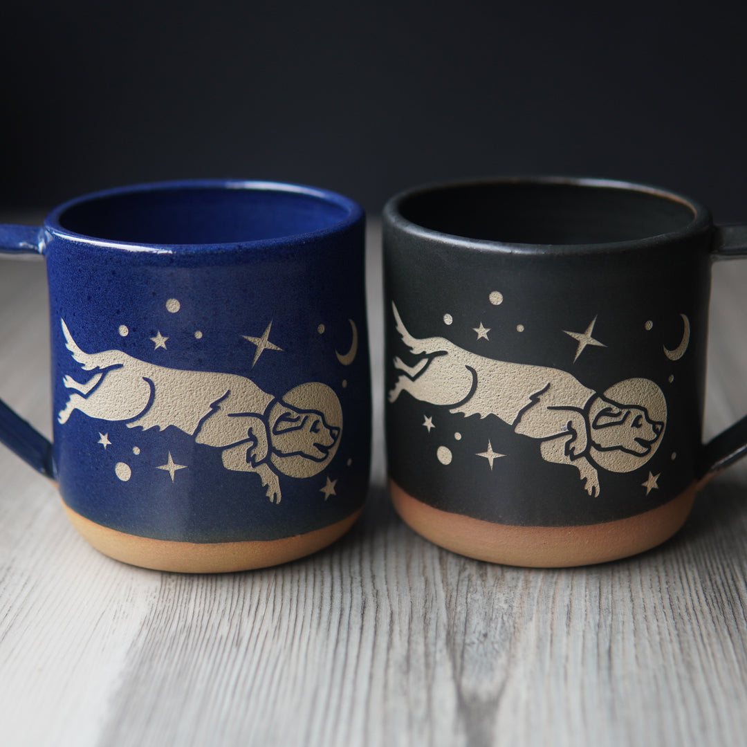 blue and black space dog mugs