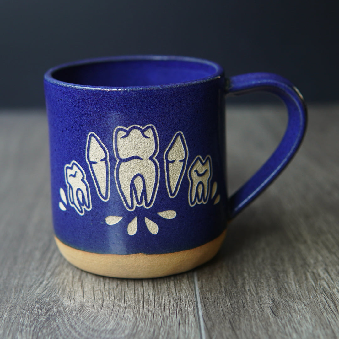 blue teeth mug with small blood droplets