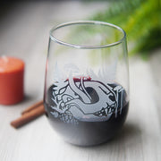stemless wine glass etched with a cat skull and mushrooms