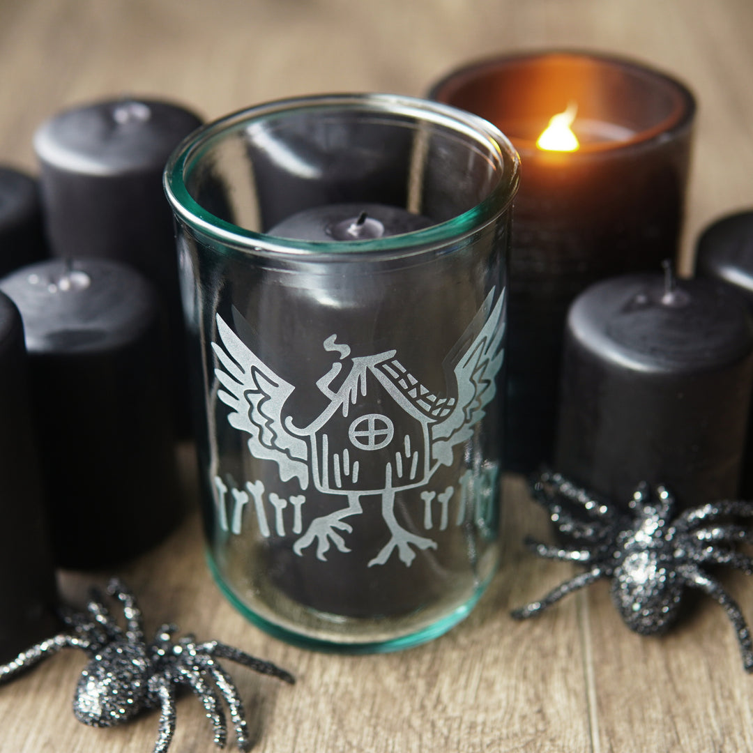 Babay Yaga's Hut etched onto a tall recycled glass candle holder