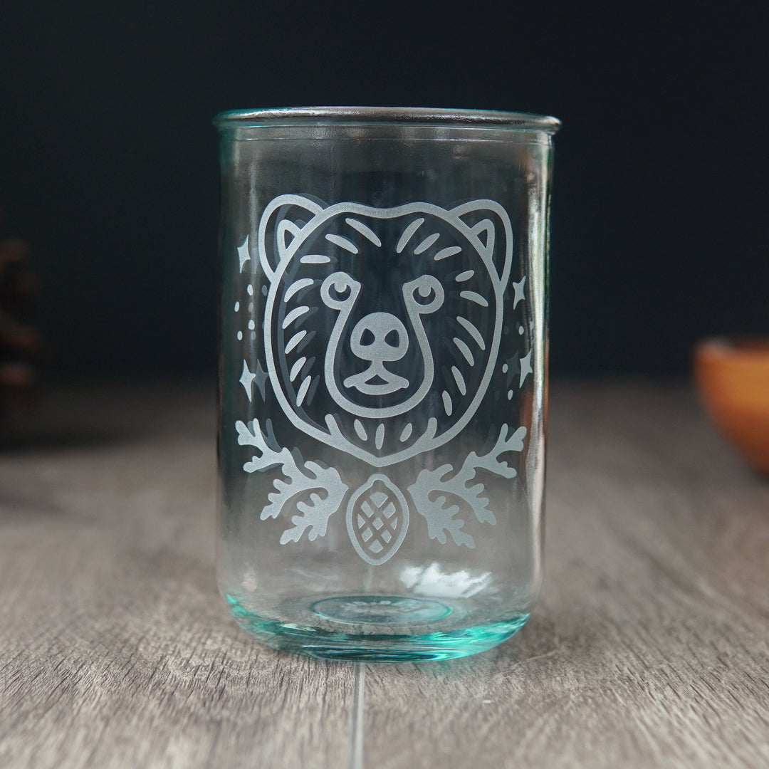 Bear head etched on a tall recycled glass cup