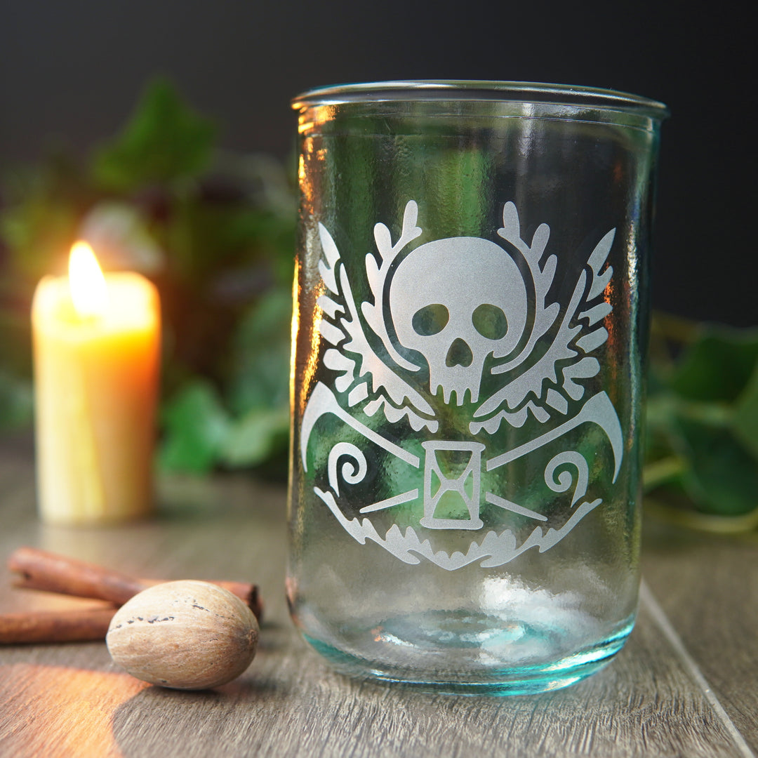 winged skull etched onto a straight-sided glass