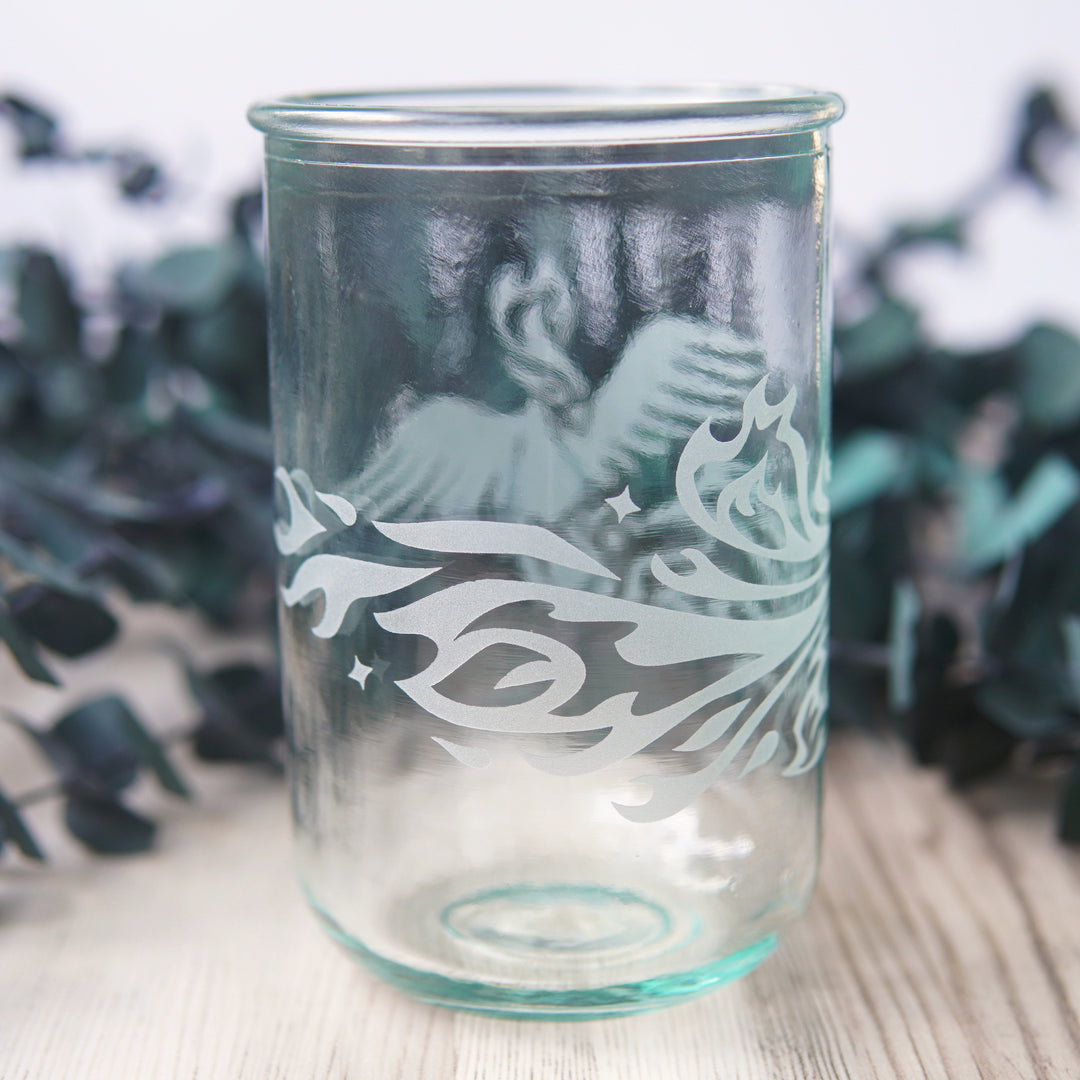 tail of a Phoenix bird engraved onto tall glass