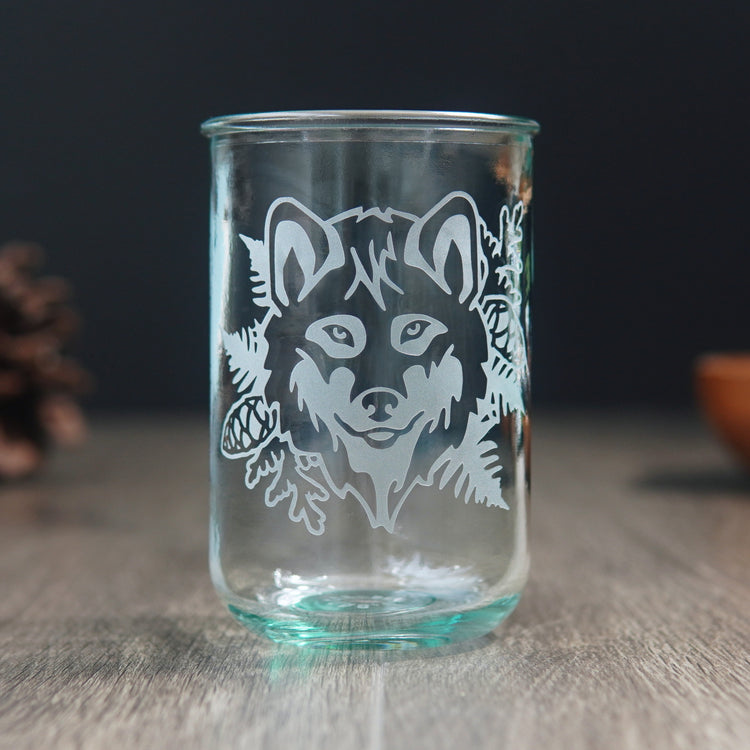 wolf head facing forward etched onto a tall glass