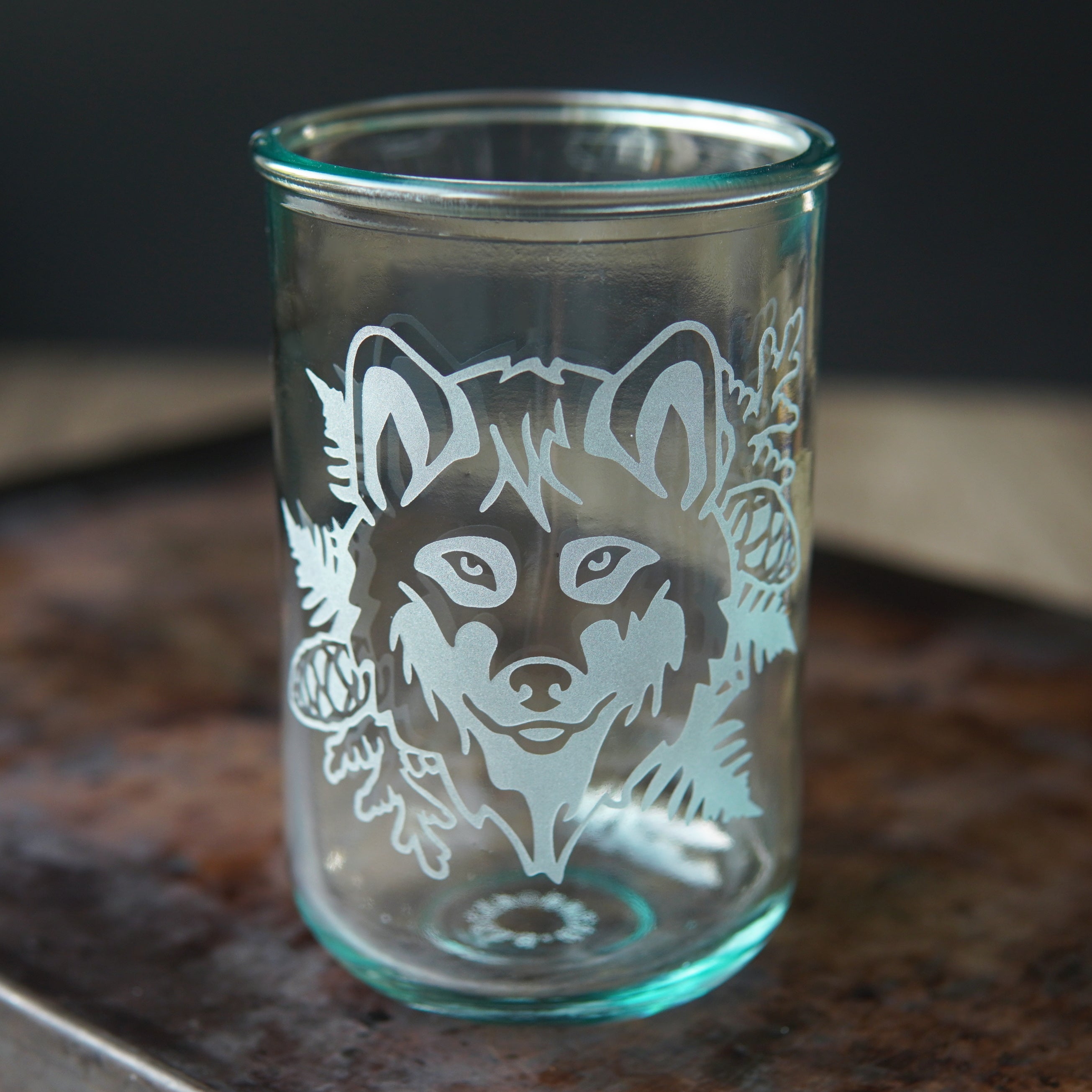 wolf etched onto a tall glass