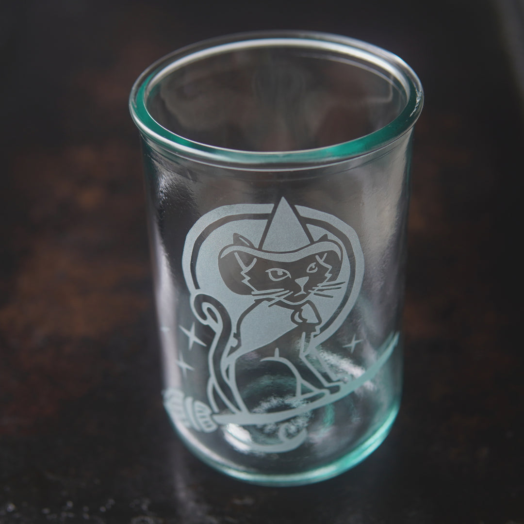 witch cat riding a broom etched onto a tall glass