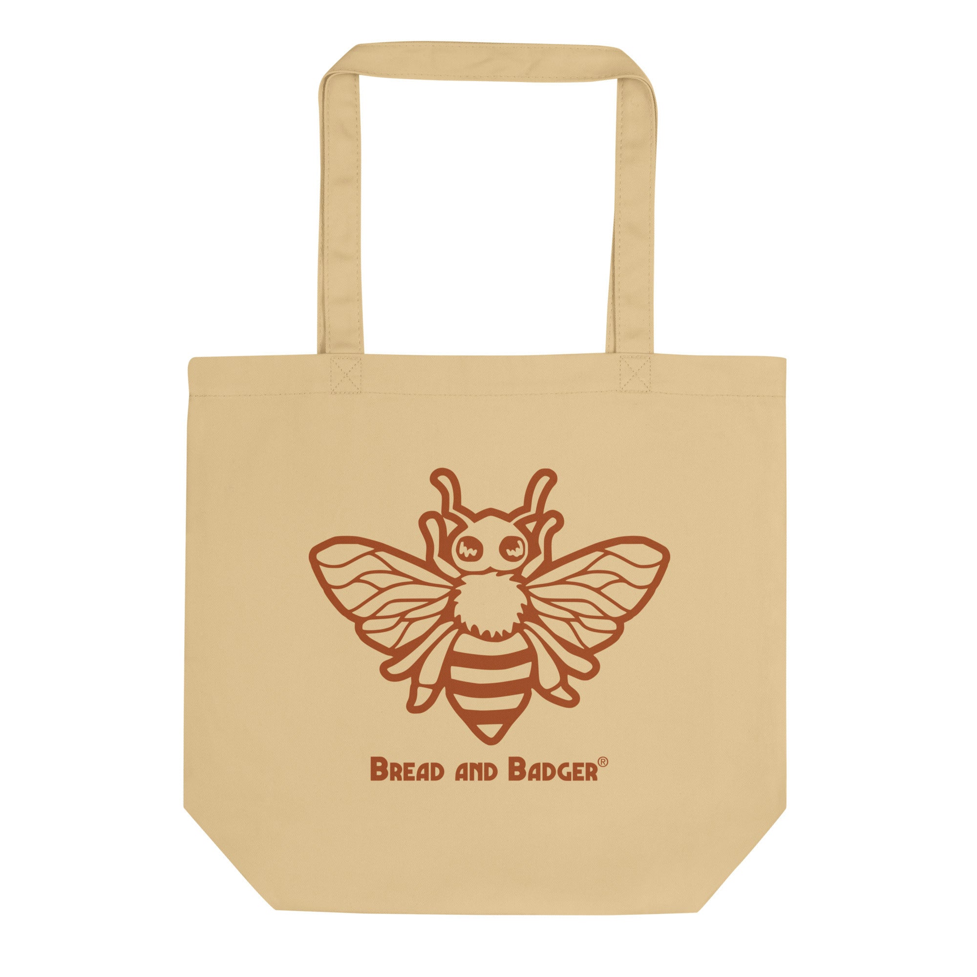 Beige tote bag with a bee design and 'Bread and Badger' text on a white background