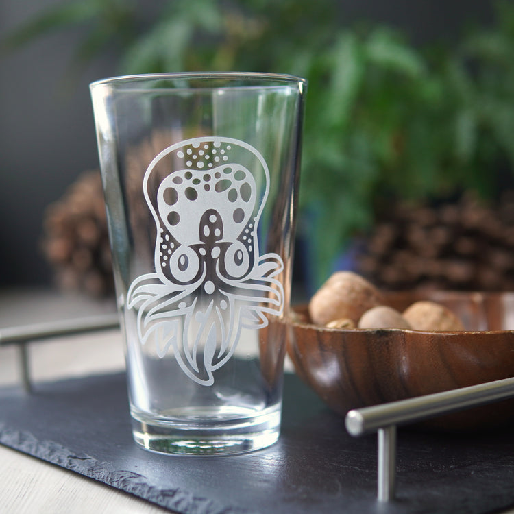 pint glass etched with a cute baby octopus. It has dots across its head and a few tentacles