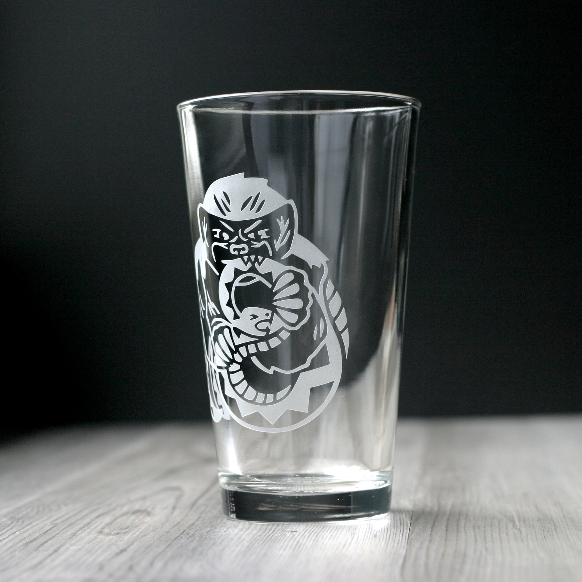 honey badger biting a snake pint glass