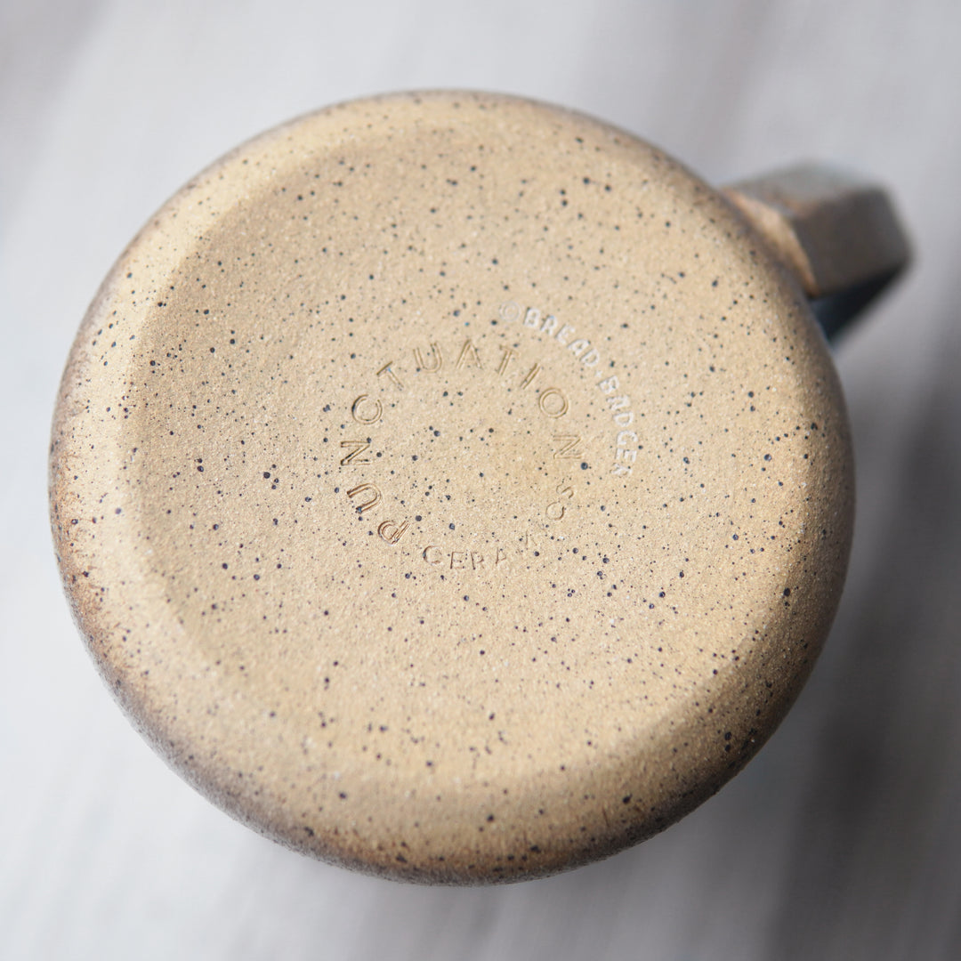 Bread and Badger logo engraved and Punctuation Ceramics logo stamped onto the bottom of a handmade mug