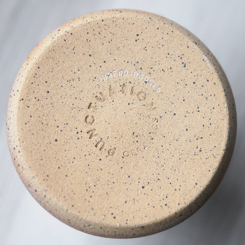 tumbler bottom stamped with Punctuation Ceramics and Bread and Badger logos