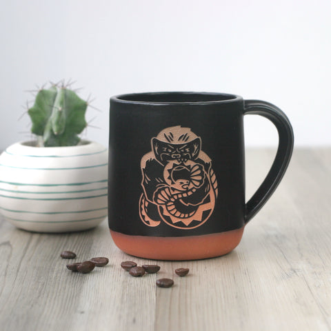 honey badgers eating snakes engraved on handmade black/red clay mugs