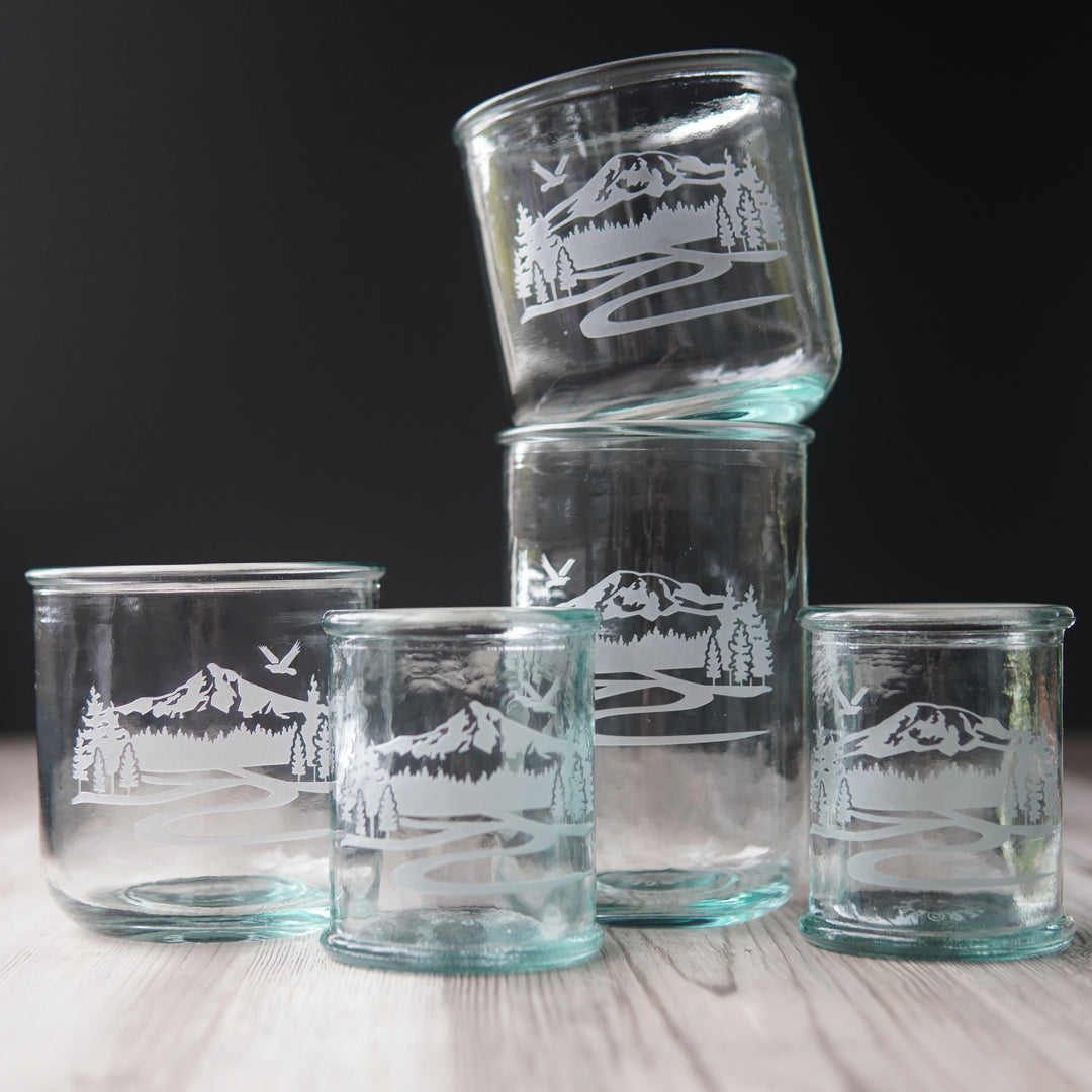 various sizes of mountain glassware tumblers with a bluegreen tinge