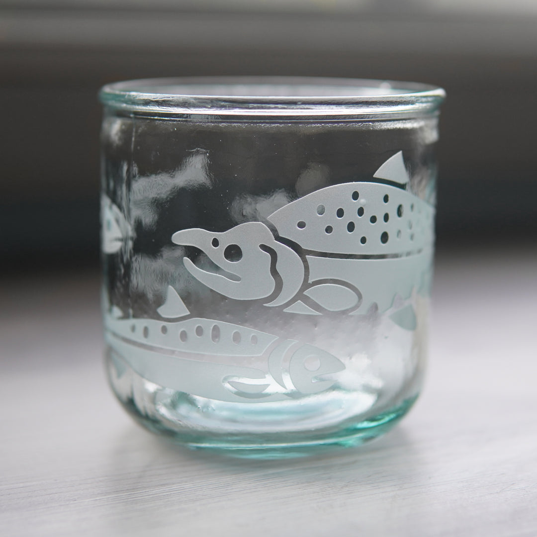 Salmon at different life stages engraved around a short glass