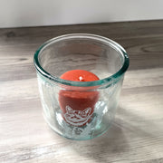 Stretching Cat short recycled glass tumbler with a votive candle in it