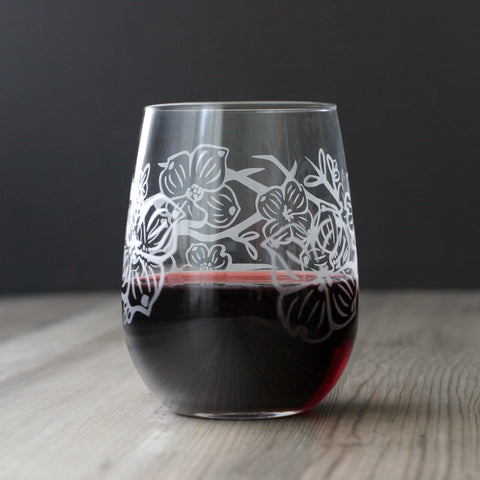 dogwood flowers engraved stemless wine glass with red wine